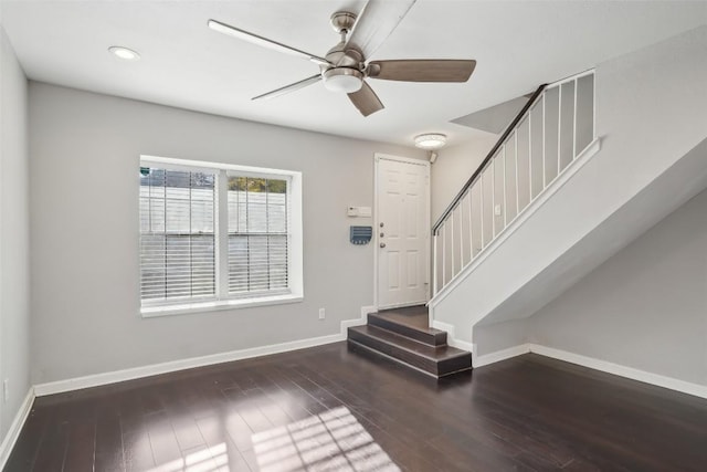 foyer entrance featuring ceiling fan and dark wood-type flooring