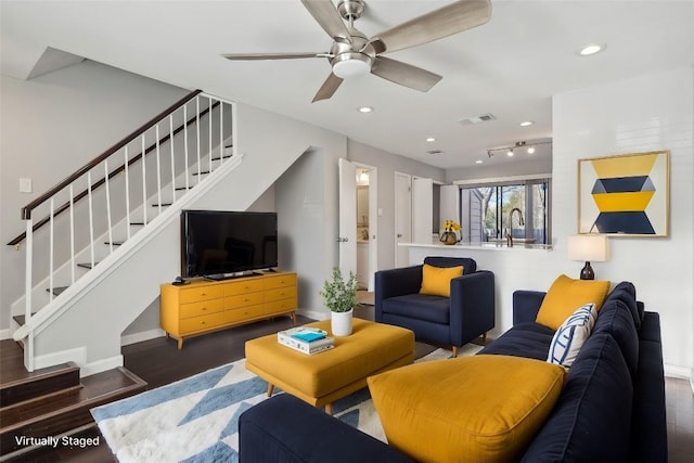 living room with dark hardwood / wood-style floors, ceiling fan, and sink