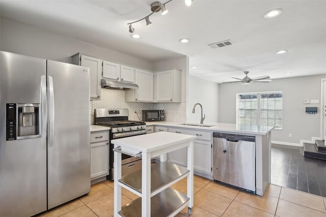 kitchen featuring light tile patterned flooring, sink, white cabinets, and stainless steel appliances