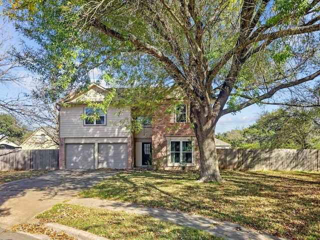 view of front of home featuring a front yard and a garage