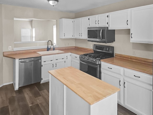 kitchen featuring dark hardwood / wood-style floors, white cabinetry, sink, and appliances with stainless steel finishes