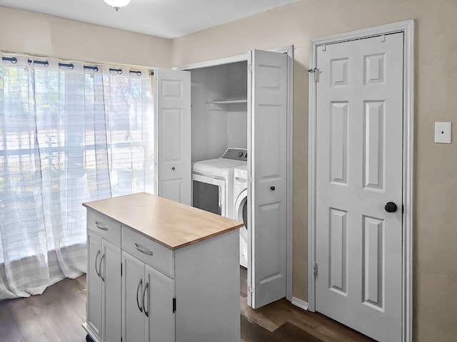 laundry area with dark wood-type flooring