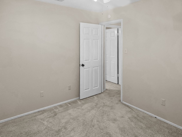 carpeted empty room with ceiling fan