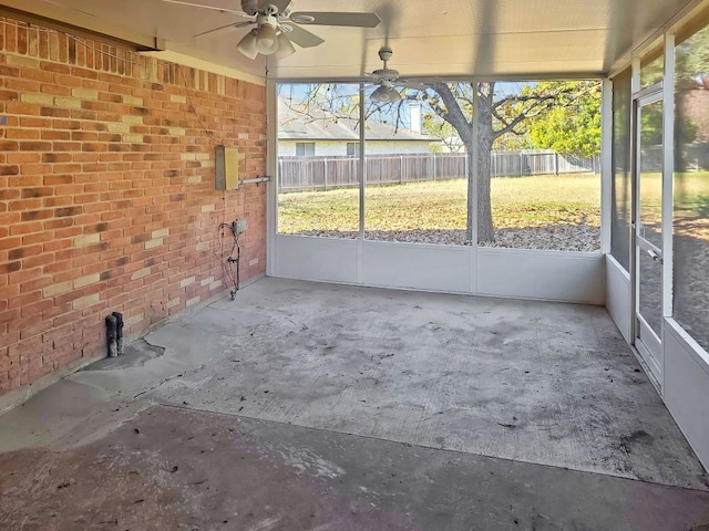 unfurnished sunroom featuring ceiling fan