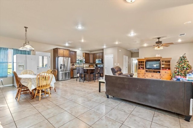 tiled living room featuring ceiling fan