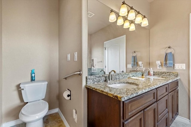 bathroom featuring toilet, vanity, tile patterned floors, and a notable chandelier