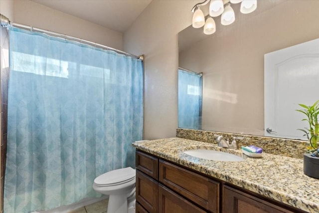 bathroom with tile patterned flooring, vanity, and toilet