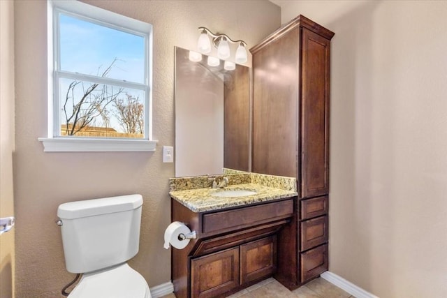 bathroom with tile patterned floors, vanity, and toilet