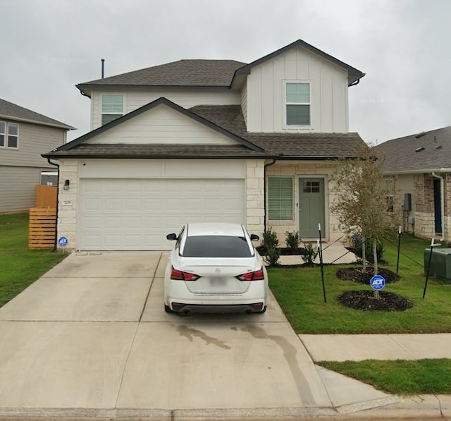 view of front facade featuring a front yard and a garage