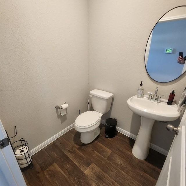 bathroom featuring hardwood / wood-style floors and toilet