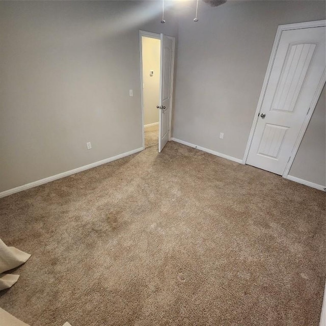 spare room featuring light colored carpet