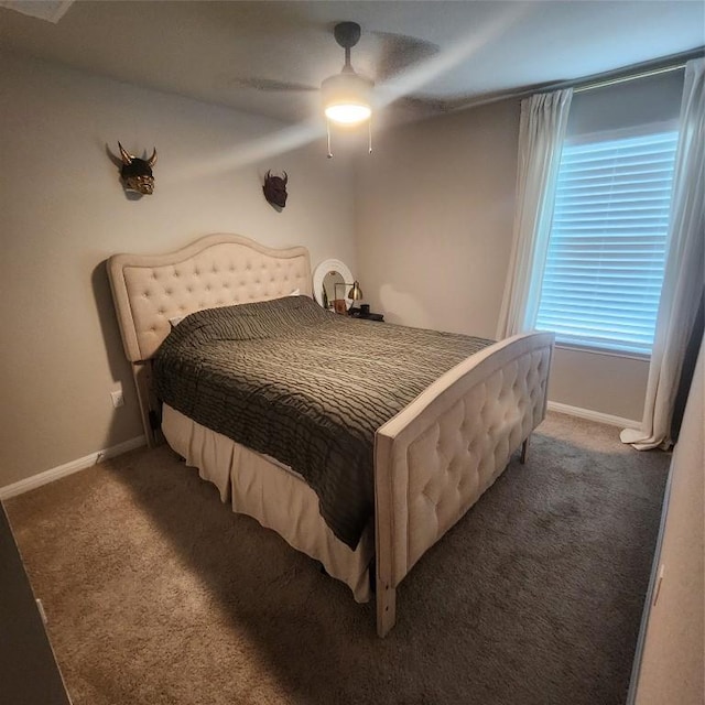 bedroom featuring ceiling fan and dark carpet