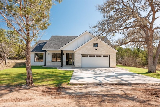 modern farmhouse style home featuring a front lawn and a garage