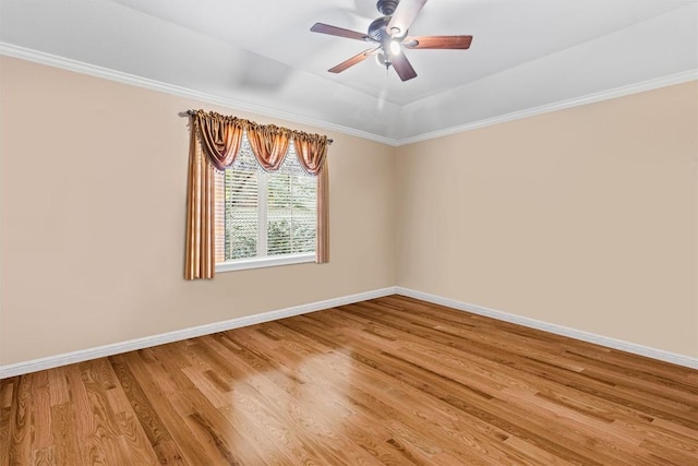 unfurnished room featuring ceiling fan, wood-type flooring, and ornamental molding