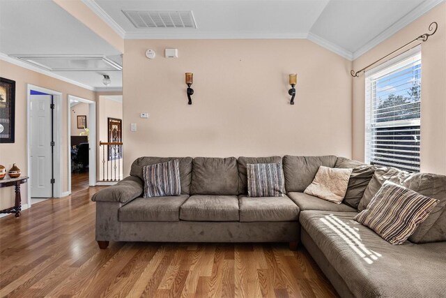 living room featuring crown molding, hardwood / wood-style floors, and lofted ceiling