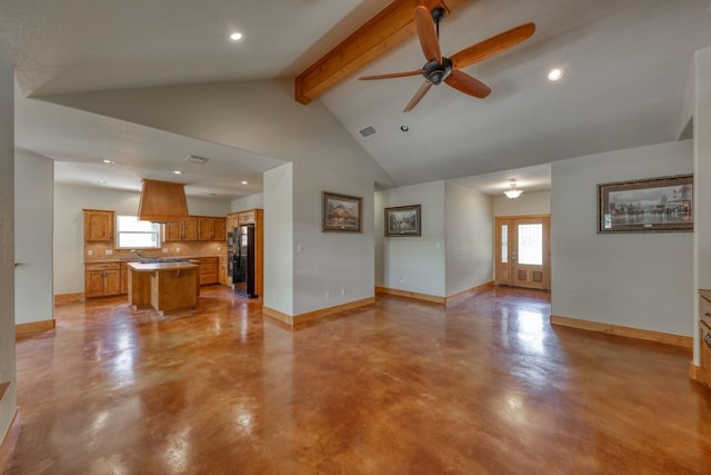 unfurnished living room with beamed ceiling, high vaulted ceiling, ceiling fan, and sink