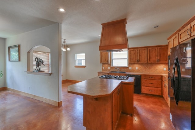 kitchen featuring concrete flooring, custom range hood, a textured ceiling, black appliances, and a kitchen island