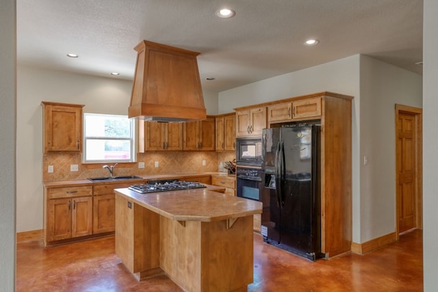 kitchen with a center island, black appliances, sink, custom range hood, and a breakfast bar area