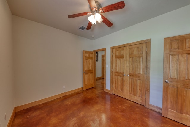 unfurnished bedroom with ceiling fan and concrete floors