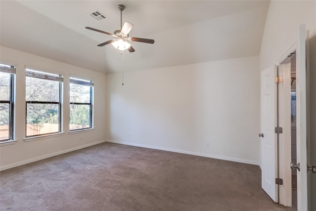 carpeted spare room featuring lofted ceiling and ceiling fan