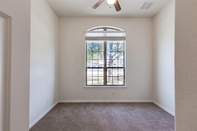 carpeted spare room with ceiling fan