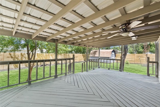 wooden deck featuring ceiling fan and a yard