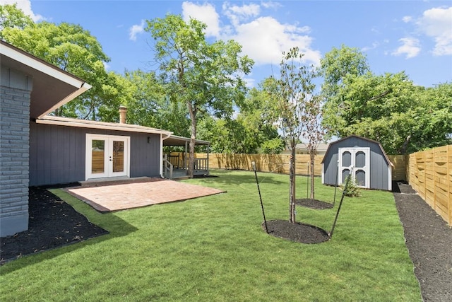 view of yard with french doors, a patio, and a storage shed