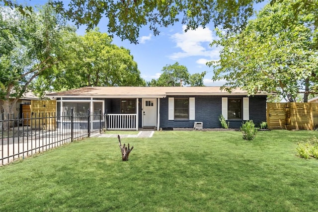 ranch-style home with a sunroom and a front yard