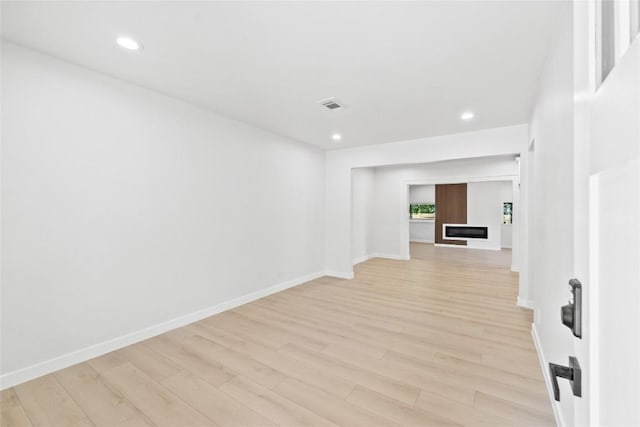 unfurnished room with light hardwood / wood-style floors