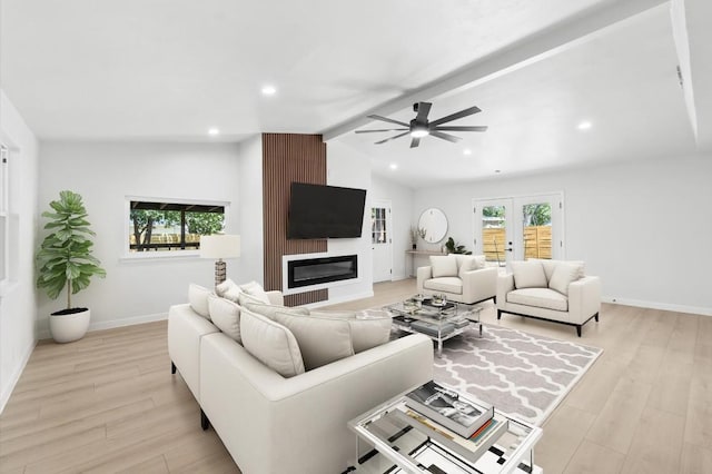 living room featuring ceiling fan, french doors, vaulted ceiling with beams, a fireplace, and light wood-type flooring