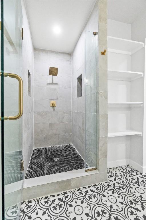 bathroom with tile patterned floors and walk in shower