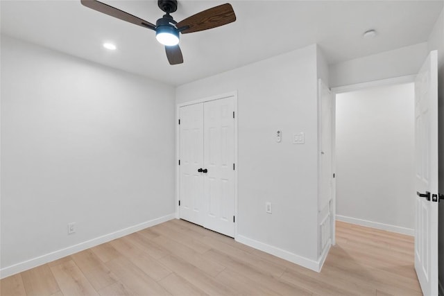 unfurnished bedroom with light wood-type flooring, a closet, and ceiling fan