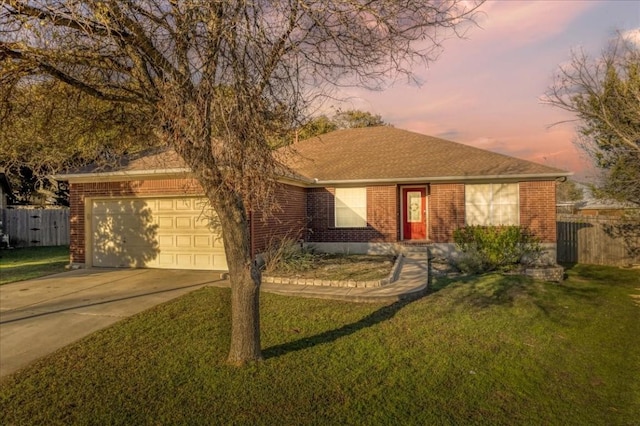 single story home with a lawn and a garage