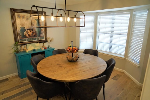 dining area with hardwood / wood-style flooring