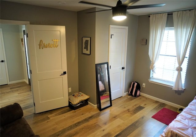 bedroom with ceiling fan and light hardwood / wood-style floors