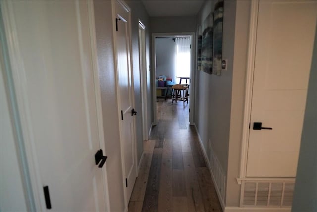 hallway with dark wood-type flooring