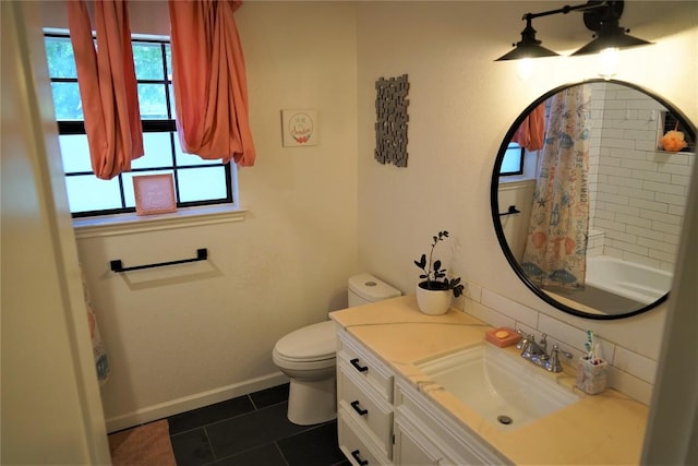 bathroom with tile patterned flooring, vanity, and toilet