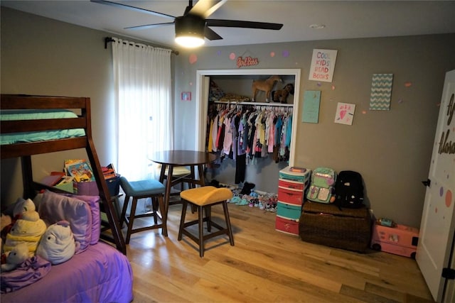 bedroom featuring ceiling fan, a closet, and hardwood / wood-style floors