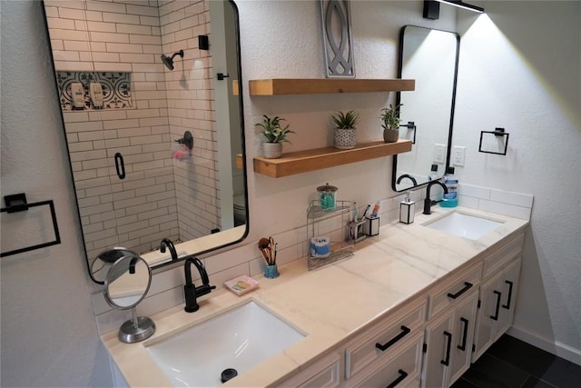 bathroom featuring tile patterned floors, toilet, vanity, and tiled shower