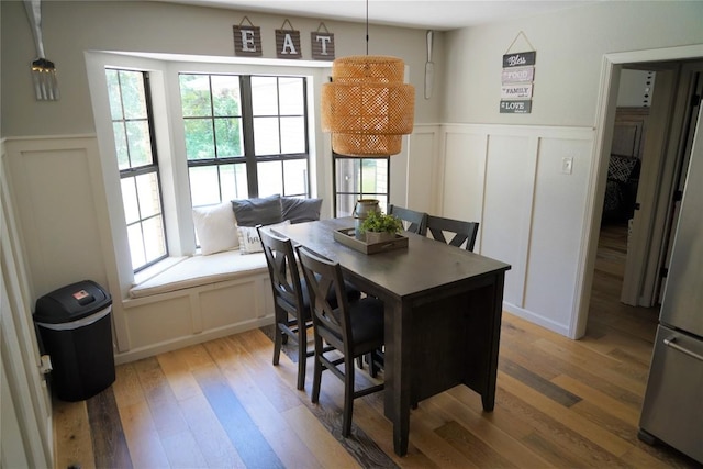 dining space with a healthy amount of sunlight and wood-type flooring