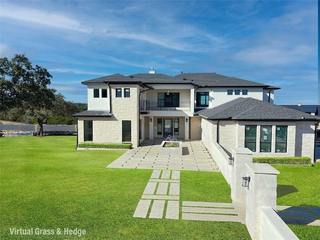 back of property with a balcony and a lawn