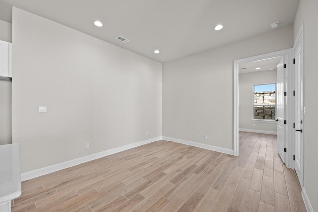 spare room featuring light wood-type flooring