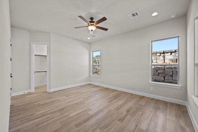 empty room featuring ceiling fan and light hardwood / wood-style floors