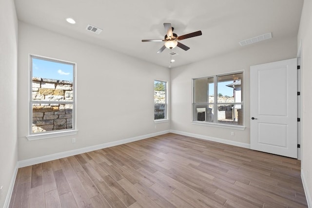 unfurnished room with hardwood / wood-style flooring and ceiling fan