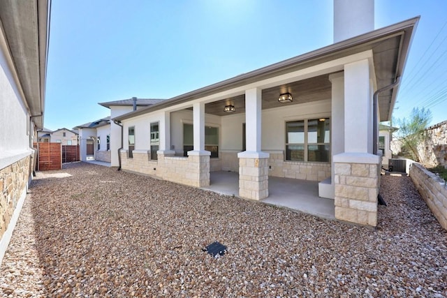 529 Clubhouse Dr, Georgetown, TX 78628 - back of house featuring stone siding and a chimney