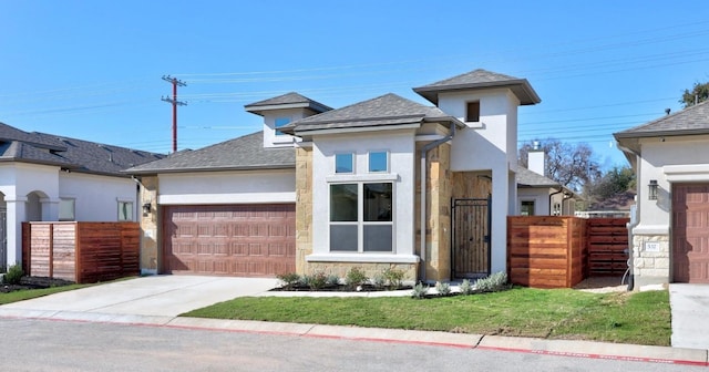 view of front of home featuring a garage and a front lawn