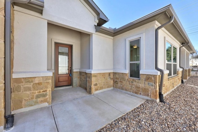 view of exterior entry featuring a patio