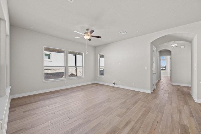 empty room with ceiling fan and light hardwood / wood-style flooring