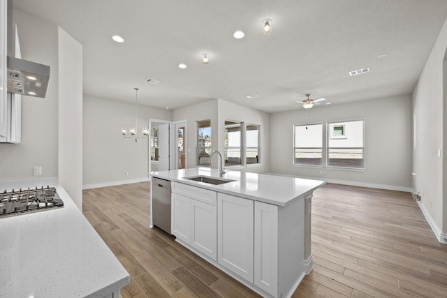 kitchen featuring an island with sink, white cabinetry, light hardwood / wood-style floors, and sink