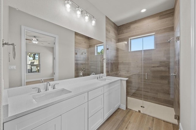 bathroom with walk in shower, a wealth of natural light, vanity, and hardwood / wood-style flooring